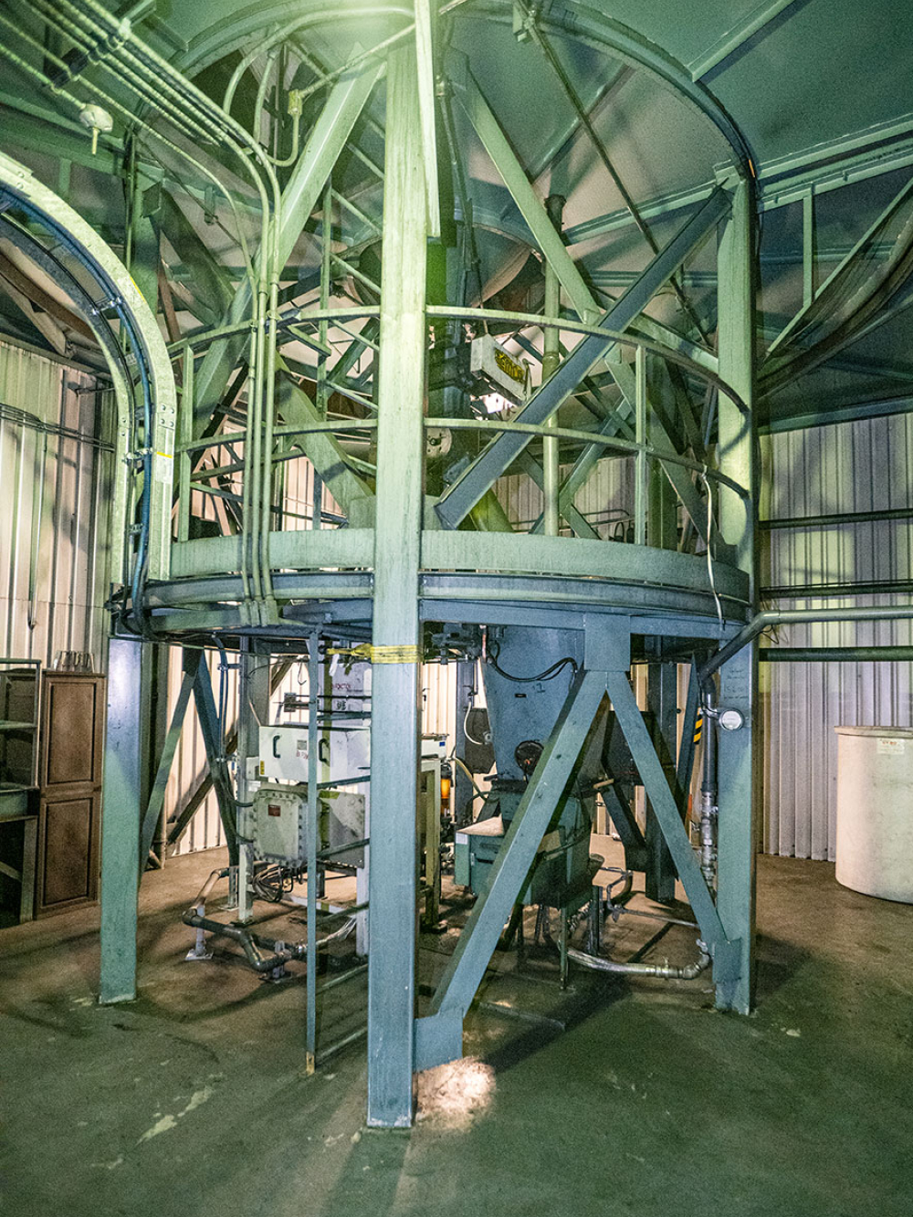 Salle de stockage contenant de grands réservoirs blancs numérotés.