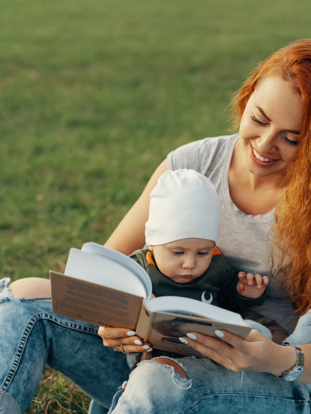 Un bébé et sa maman lisent un livre dans un parc, une activité de la bibliothèque Paul-O.-Trépanier